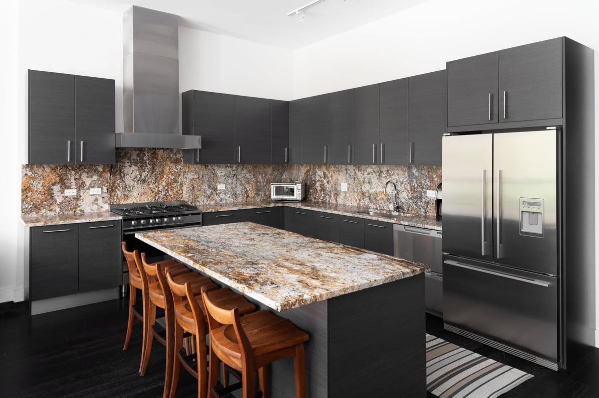 Modern kitchen with granite countertops, a large island, and stainless steel appliances