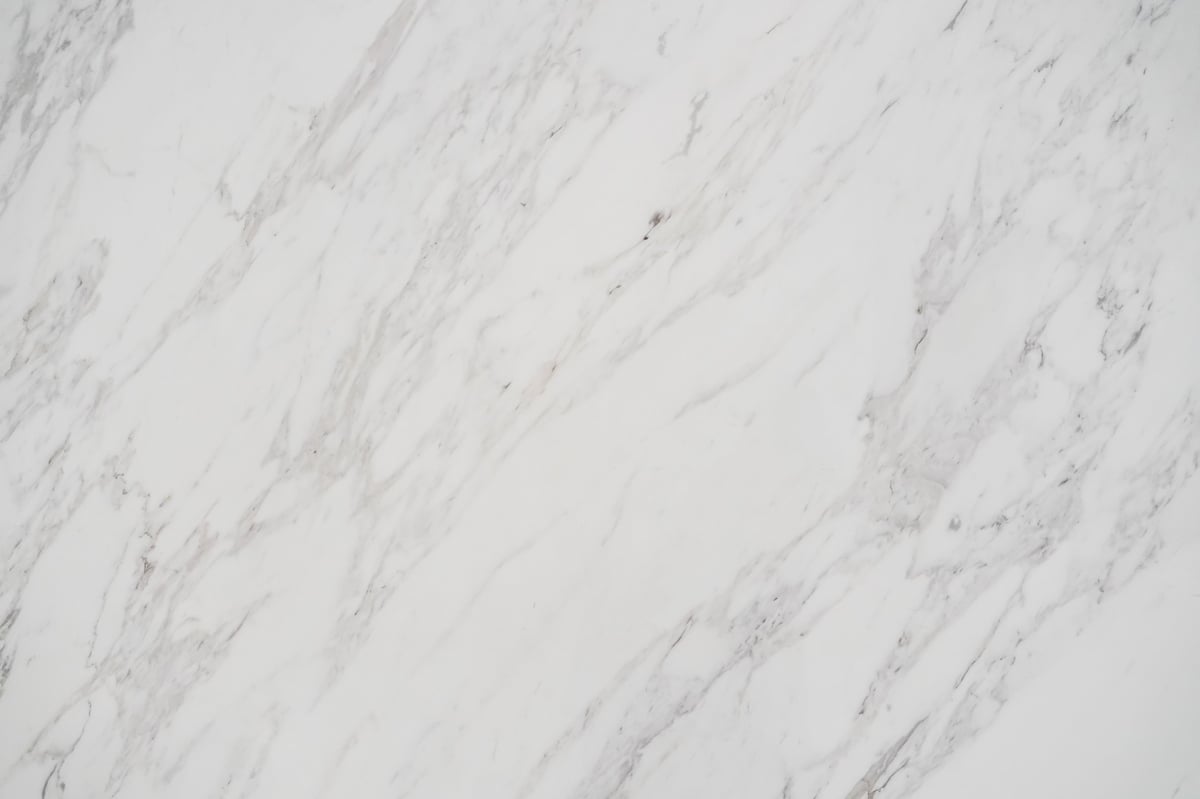 Polished white marble slab with intricate natural grey veining